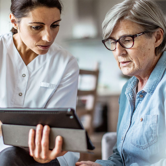 A nurse engaging in conversation with her patien