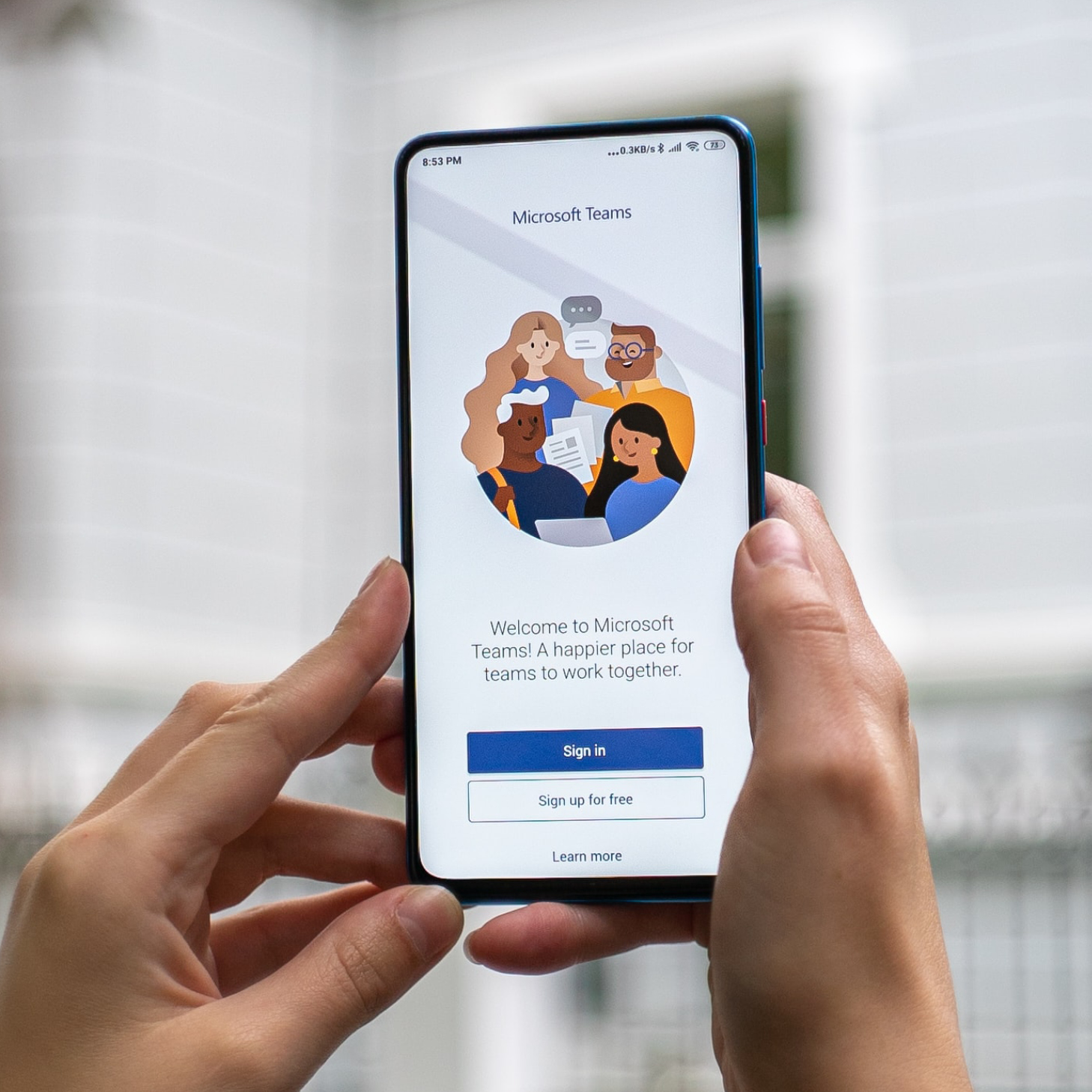 A close up of a persons hands holding up a mobile phone with an app open on the screen