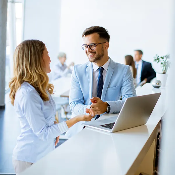 Business colleagues working and discussing at a laptop in the office