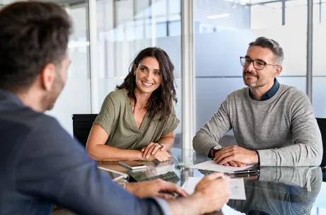 Three business people conversing at a table