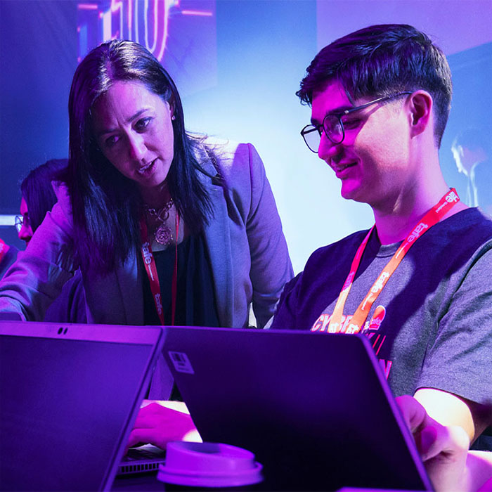 TAFE student showing an information to his teacher