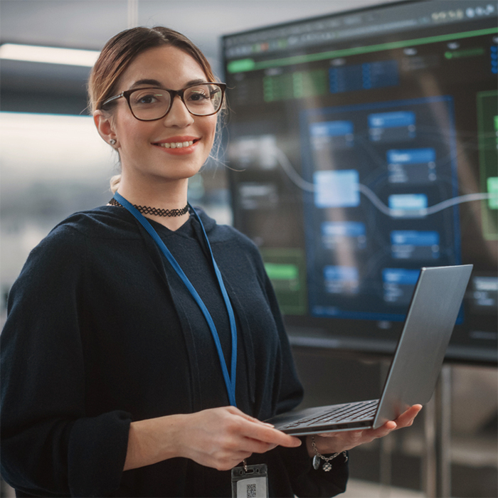 Women engineer holding a laptop in a data center